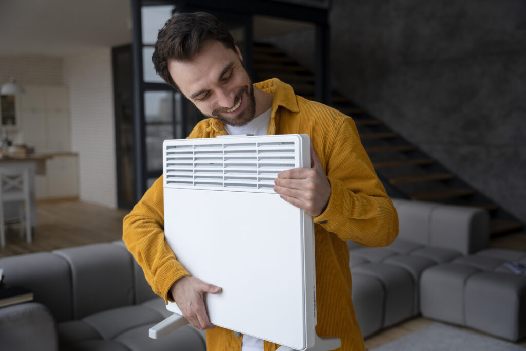 medium shot smiley man holding heater